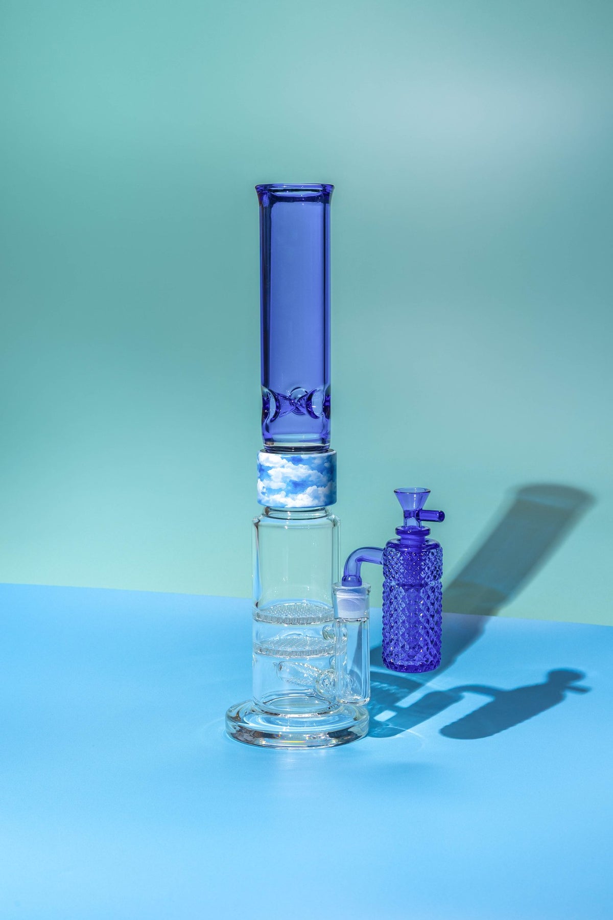 Jane West x Prism Sapphire Blue 14mm 90 degree ash catcher on a Prism percolator water pipe