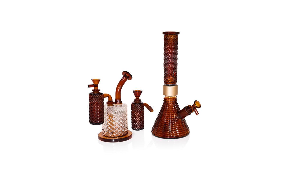 Jane West Twenties Collection Amber Water Pipe with matching Amber 90 degree ash catcher, beside the Amber Jane West x Prism modular water pipe
